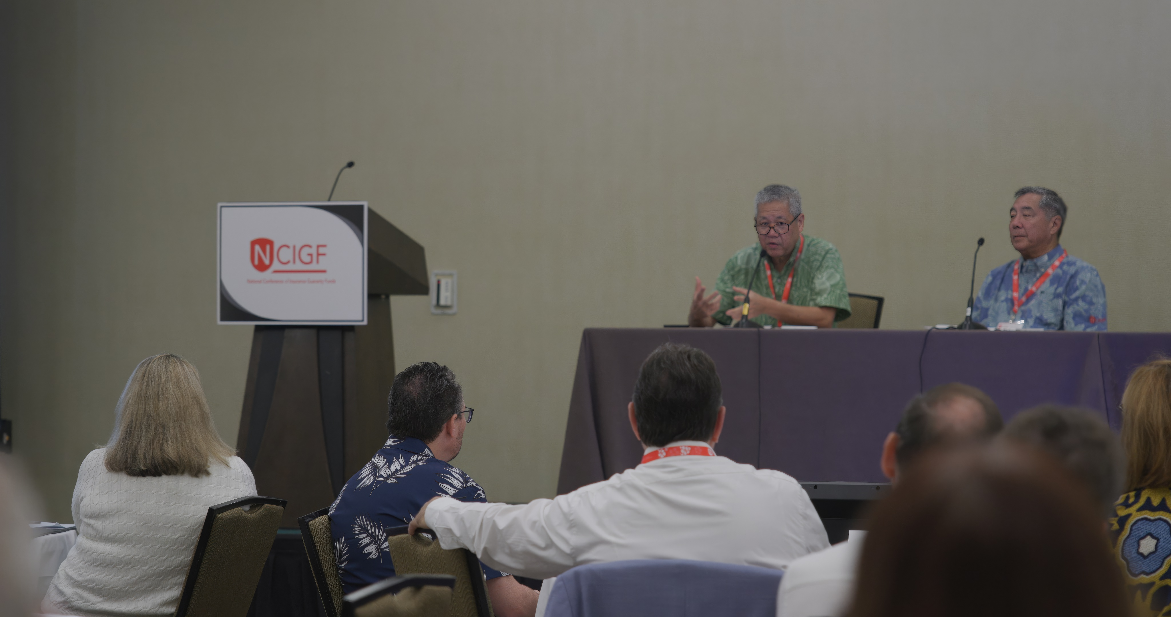 IMG_4633.JPG Scott Saiki, Insurance Commissioner of the Hawaii Department of Commerce and Consumer Affairs Insurance Division, and Blake Obata, Administrator of the Hawaii Insurance Guaranty Association, deliver the opening remarks for Day 1